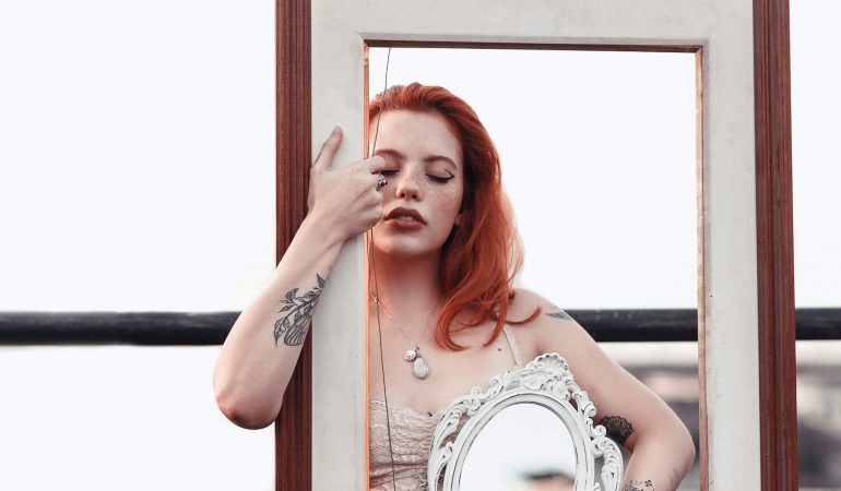 woman-carrying-white-and-brown-decorative-frame